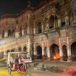 Beautiful architecture, people squatting making fire