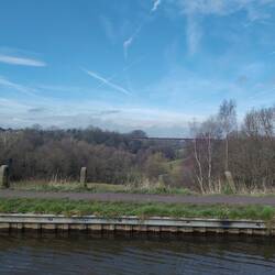 The long North Staffordshire railway viaduct blending onto the wooded slopes.