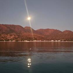 Moon setting in the morning looking back at the beach