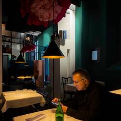 Mui perusing the wine menu for a red from the Emilia-Romagna Region ... at I Conoscenti — Bologna.