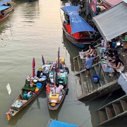 Floating food vendors making and selling tasty meals from their longtail boats