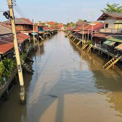 Amphawa market felt a bit dreamy with traditional wooden buildings and afternoon light.
