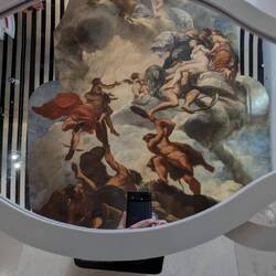 Looking through a mirror to see the painted ceiling