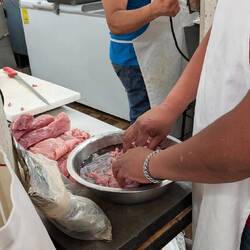 Meat being prepared for grilling