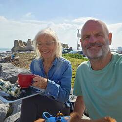 Morning coffee on the wave breaker of the harbour