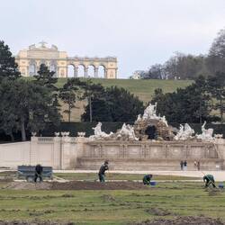 Gardeners at work, and looking off to a celebratory arch for their one (?) battle victory.