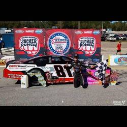 One of Mike's jobs is to hold the BFS. Big f* sign he is holding the red signs behind the car