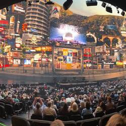 The background projection is active showing album covers, venues and over time, more signs turn on.