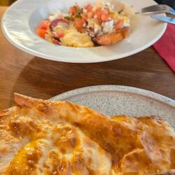 Breakfast of Banitsa pastry and scrambled eggs with sausage and goat cheese