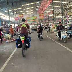 We cut through an immense warehouse housing Pathom Mongkul Market full of colourful produce