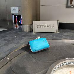 The multi coloured backpack could not be missed and was first of the plane