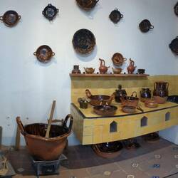 A kitchen. The stove is the yellow tiles area.