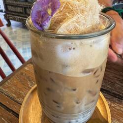 Pretty iced coffee topped with coconut candy floss, an Ayutthaya speciality.