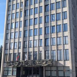 City Hall with city coat of arms under white flag (building courtesy of the Communists).