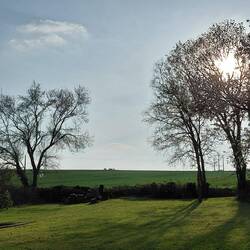 The farmer and his tractor appeared on the horizon one evening