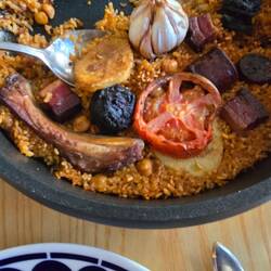 A rice dish (similar to paella) with pork ribs, chorizo, bacon, and blood sausage.