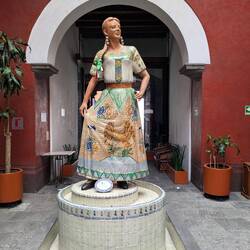 A statue in the house/now hotel where she worked as a servant.