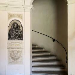 The circular staircase in the foyer goes up to the Carducci apartment — Bologna, Italy.