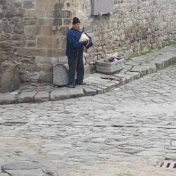 Busker playing the bag pipes of Bulgaria