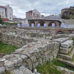 The arches in the background support the stands at the amphitheatre.