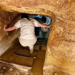 Climbing down into a burial chamber