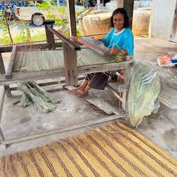 At lunchtime our cook took us to see his mother at her loom under the house next door.