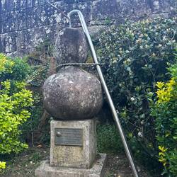 A gourd and staff that are pilgrim emblems.