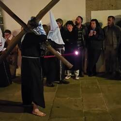 Nazarenos carrying crosses in the late procession.