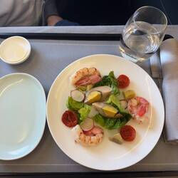 Appetizer on CX292. This was poorly executed; the prawns were overcooked and avocado was off color.