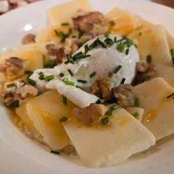 Kachamak, a traditional Bulgarian thick cornmeal porridge with truffles, cheese, egg, and walnuts