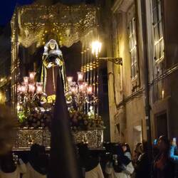 Maria escorted by a military guard and band.