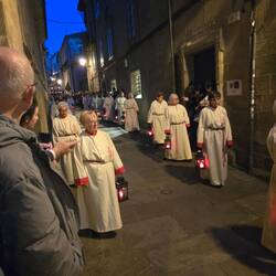 Women carrying lanterns and candles keeping vigil.