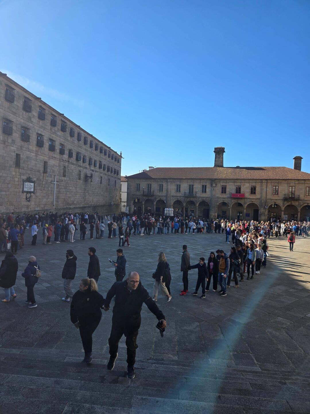The crowd is in line to enter the church for mass.