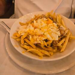 Phil had fried eggs on sausage and French fries.