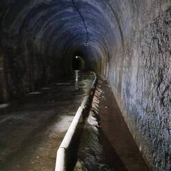 Blick in ein Tunnel mit Wasserlauf