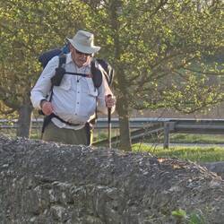 Phil crossing a stone arch bridge.