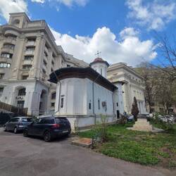 Small church that was moved and the big buildings around it