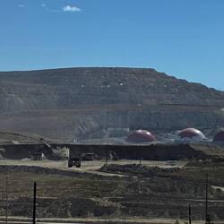 Note the digger shovelling into the trucks & on the far right a normal sized van