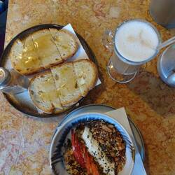 Frühstück. Butterbrot mit Honig und Zimt. Und eine Bowl mit Obst, Nüssen und Joghurt