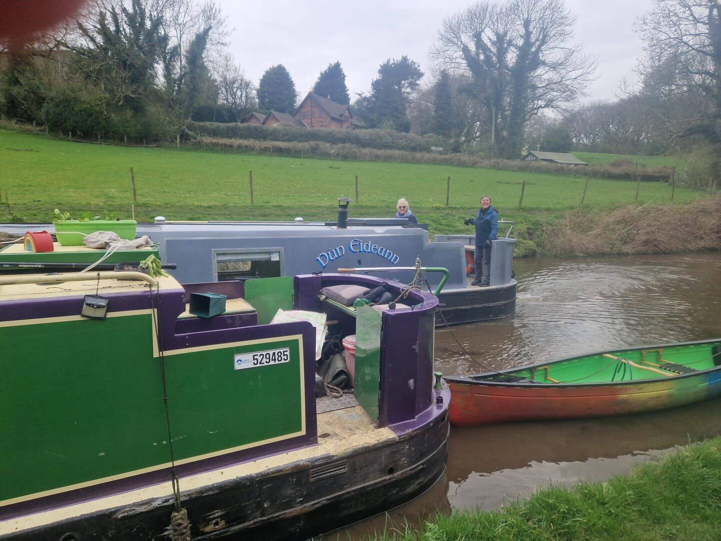 Two Cain Narrowboats together. Waving thanks and bye to Dun Eideann
