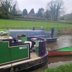 Two Cain Narrowboats together. Waving thanks and bye to Dun Eideann