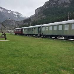 Old train cars being restored. One is a medical car..