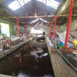 Market stalls where trains would have been and a model chinook helicopter hanging above the canal