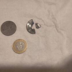 One rial for size reference. Good it was not the King's face that was eaten by the gears.