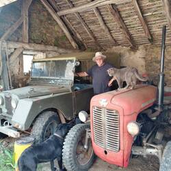 Roger in one of the outbuildings with a red Massey Ferguson tractor