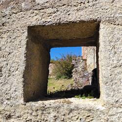 A simple square window amongst the wreckage of houses and shops