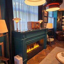 Old wooden radio above the fireplace.