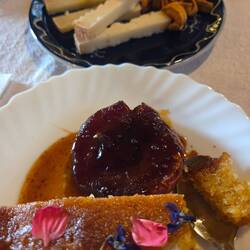 Dessert of polenta cake with baked apple, and cheese