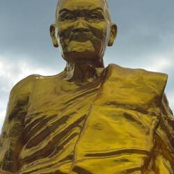 A huge golden Monk statue captures his amazing features