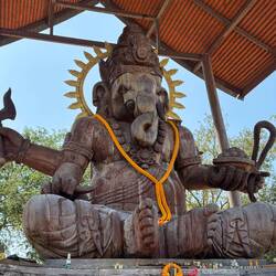 A large wooden statue of Ganesha